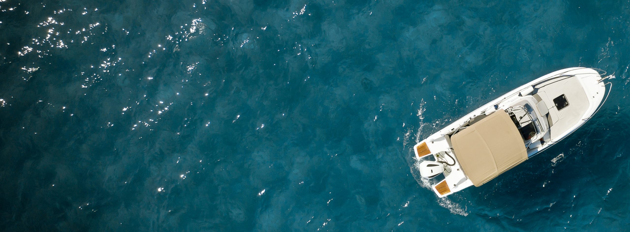 white boat in clear blue waters