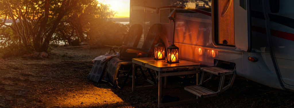 Chairs and lanterns outside of an RV