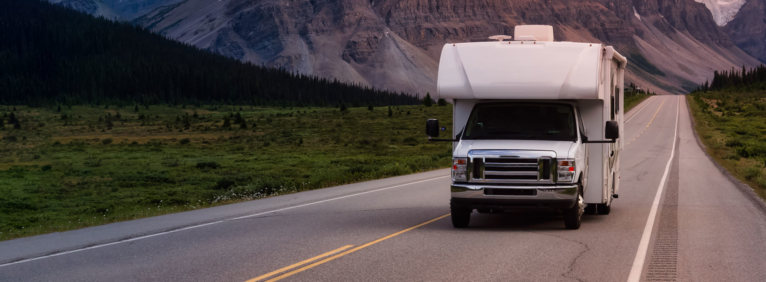 RV driving on a road with mountains